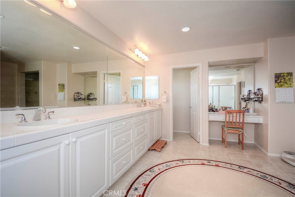 45316 St Tisbury Street Temecula, CA 92592 - Photo 27 of 62 a spacious bathroom with a sink a mirror and a shower