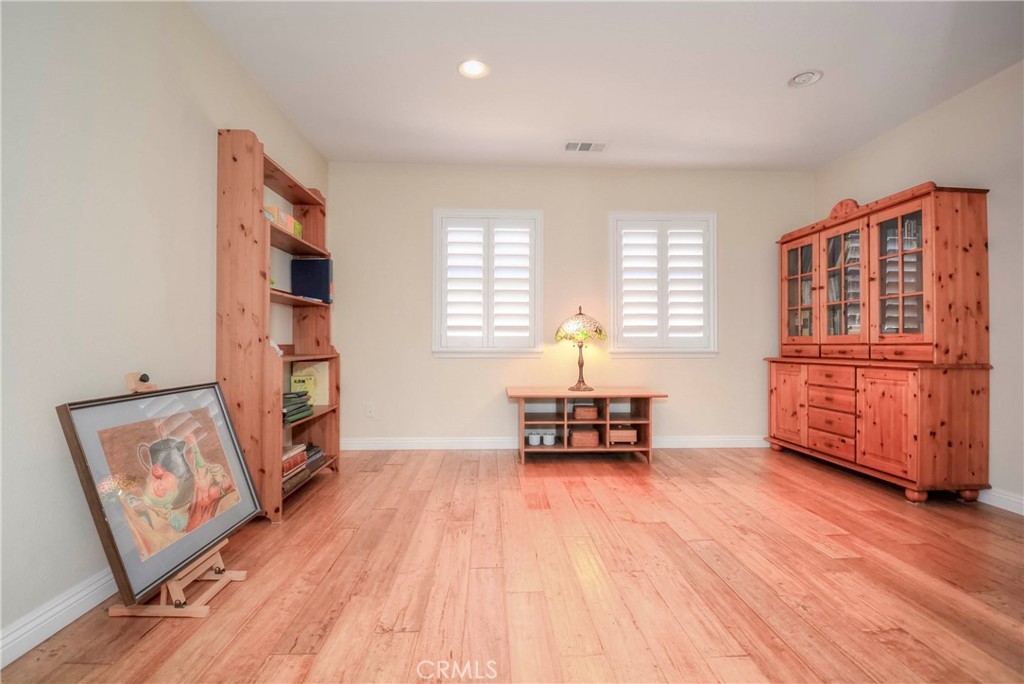 45316 St Tisbury Street Temecula, CA 92592 - Photo 32 of 62 a living room with furniture and wooden floor