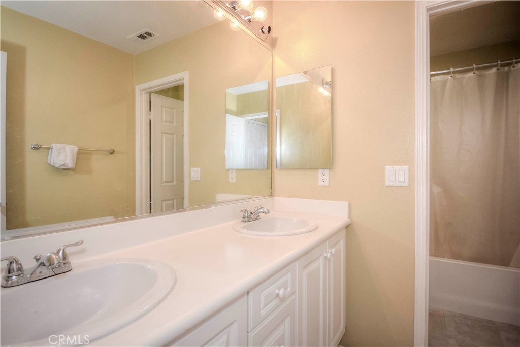 45316 St Tisbury Street Temecula, CA 92592 - Photo 36 of 62 a bathroom with a granite countertop sink and a mirror