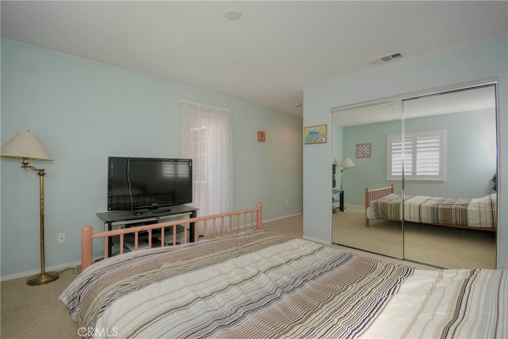 45316 St Tisbury Street Temecula, CA 92592 - Photo 42 of 62 a bedroom with a bed and a flat screen tv