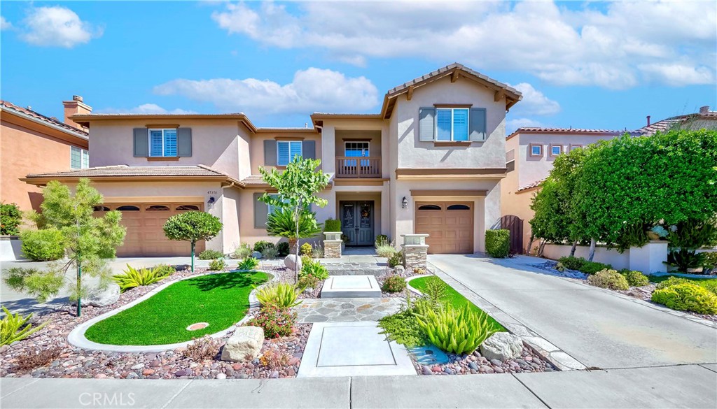 45316 St Tisbury Street Temecula, CA 92592 - Photo 5 of 62 a front view of a house with a yard and potted plants