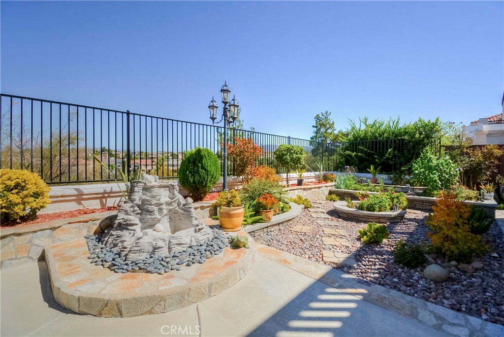 45316 St Tisbury Street Temecula, CA 92592 - Photo 53 of 62 a view of a swimming pool with potted plants and palm trees