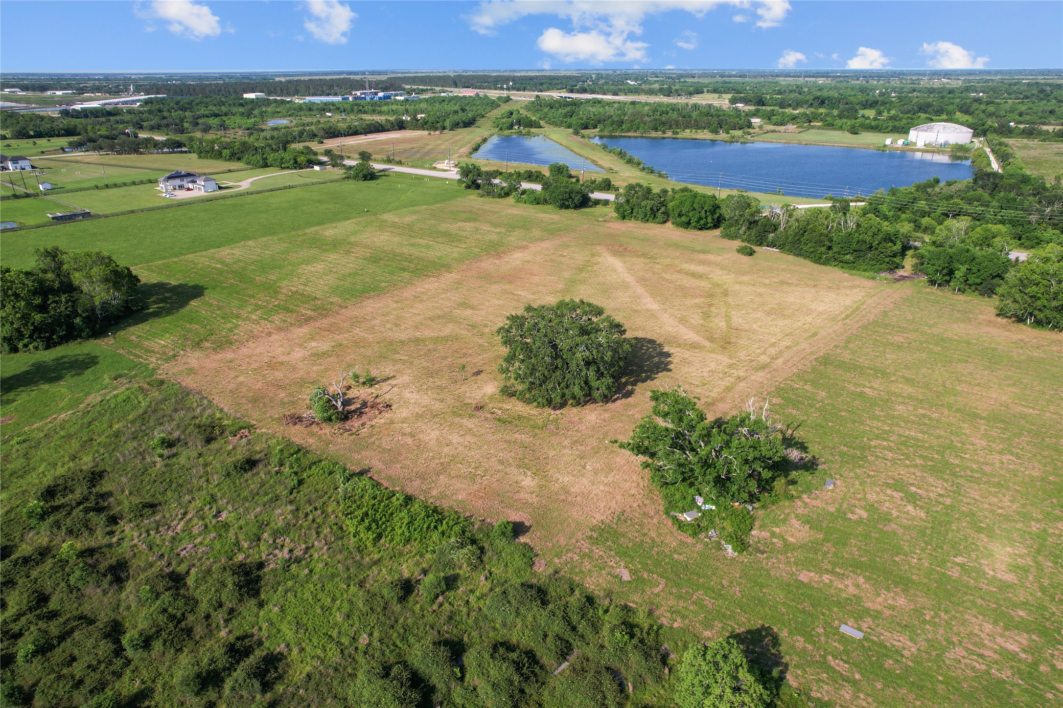 23210 FM 521 Road Angleton, TX 77515 - Photo 12 of 23 an aerial view of a house with a yard and lake view