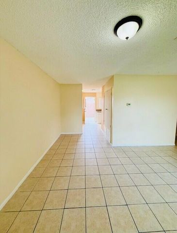 a view of a room with a white wall and a shower