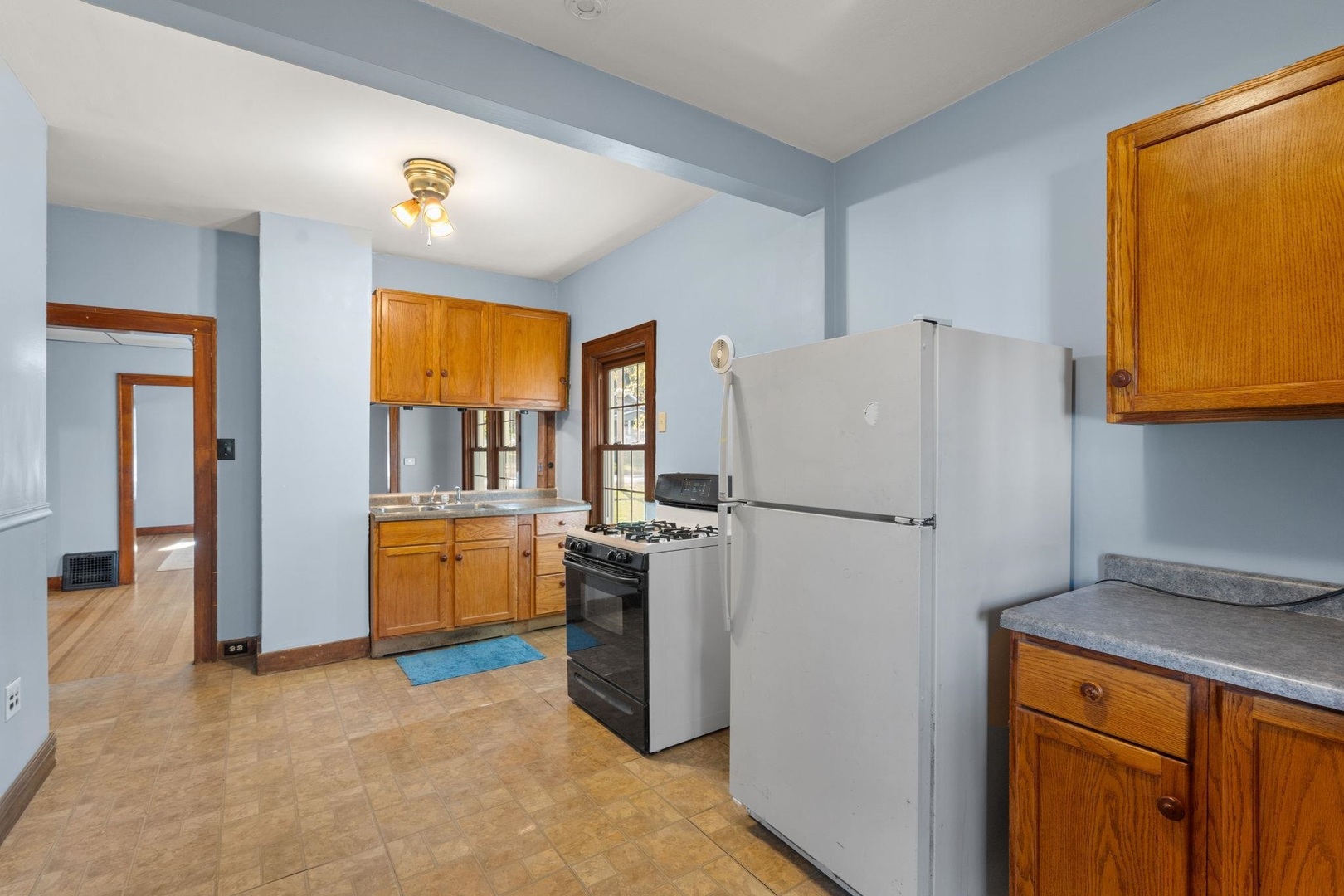 313 North 20th Street East Moline, IL 61244 - Photo 6 of 13 a kitchen with a refrigerator and a stove