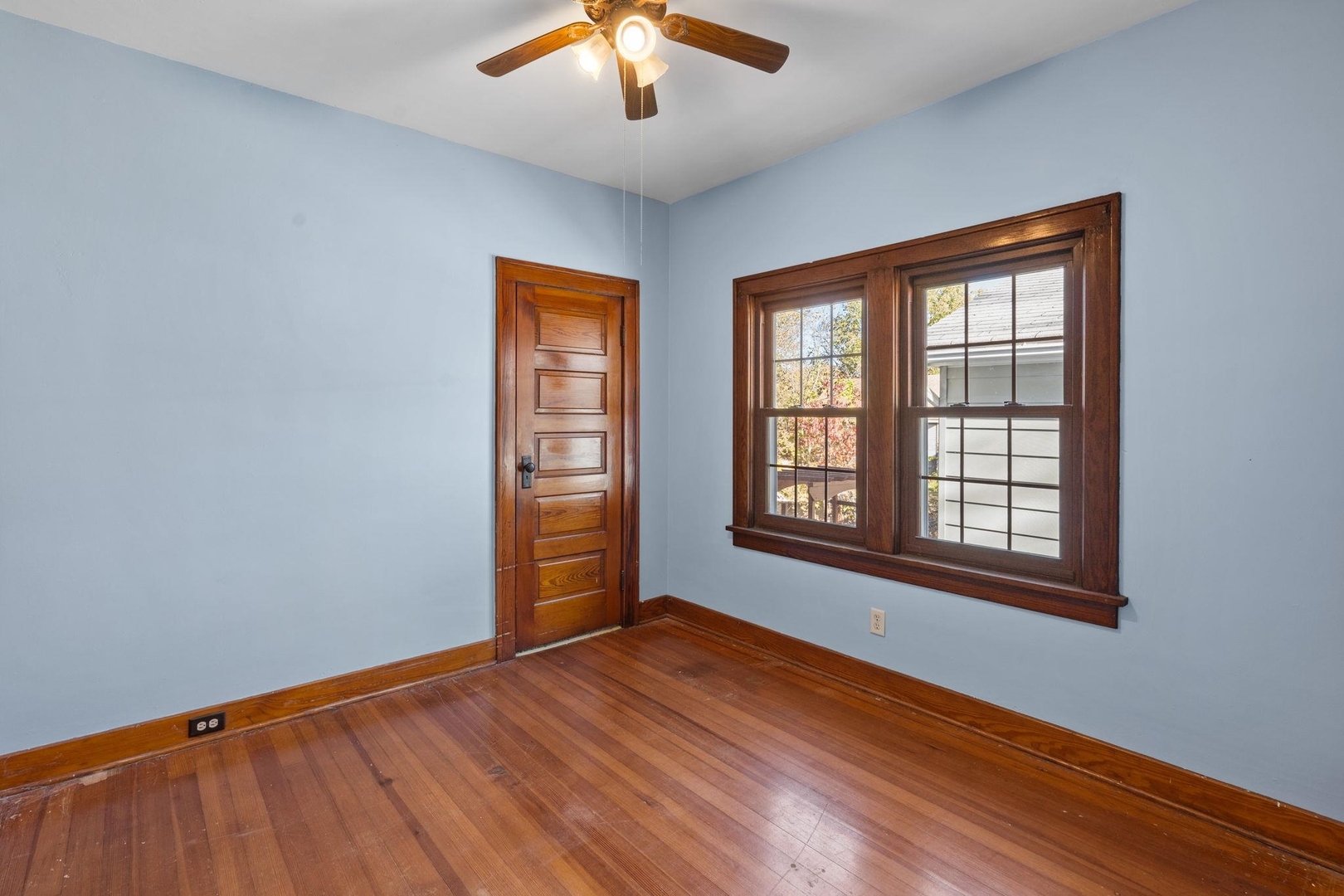 313 North 20th Street East Moline, IL 61244 - Photo 7 of 13 an empty room with wooden floor and windows