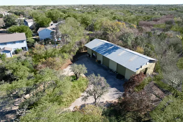 a view of a house with a yard and covered with green space