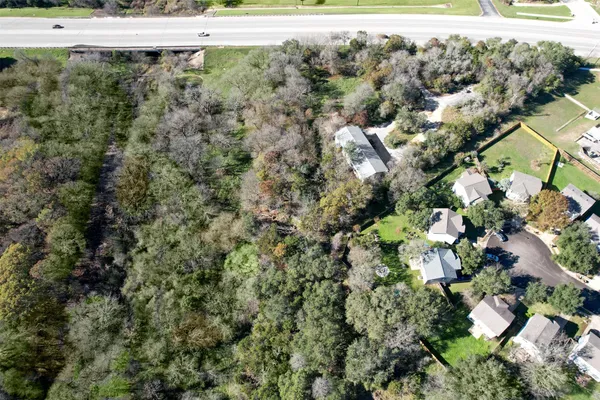 a view of a yard with wooden fence