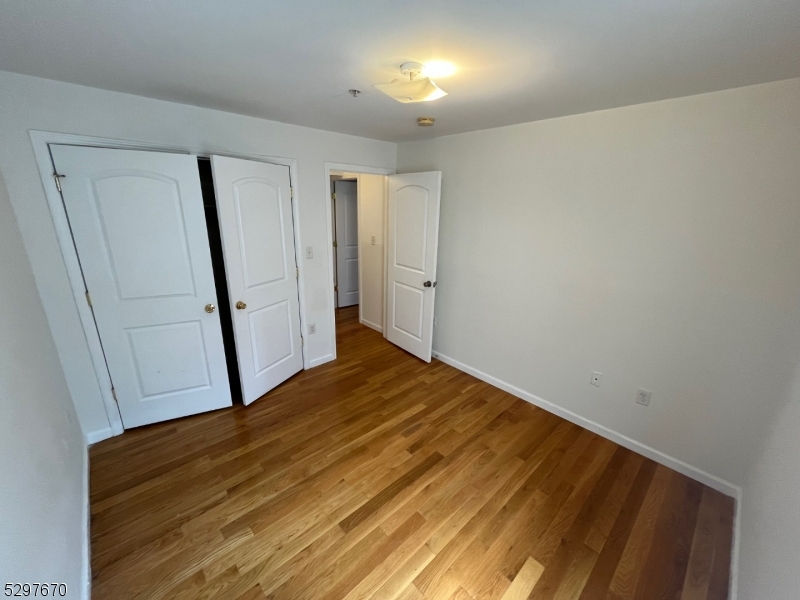 157 Lafayette Street, Unit 2 Newark, NJ 07105 - Photo 11 of 12 a view of a room with wooden floor and entryway