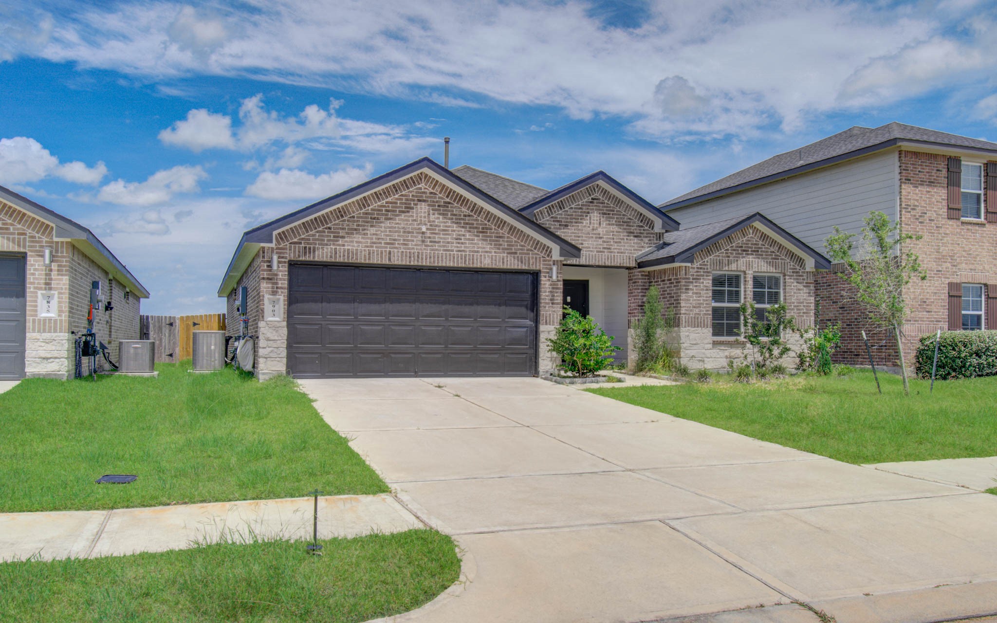 7903 Wrangler Shack Lane Rosharon, TX 77583 - Photo 3 of 29 Discover suburban charm in this modern, single-story brick home featuring a double garage, meticulously paved driveway, and quaint front lawn, all nestled in a well-maintained neighborhood.
