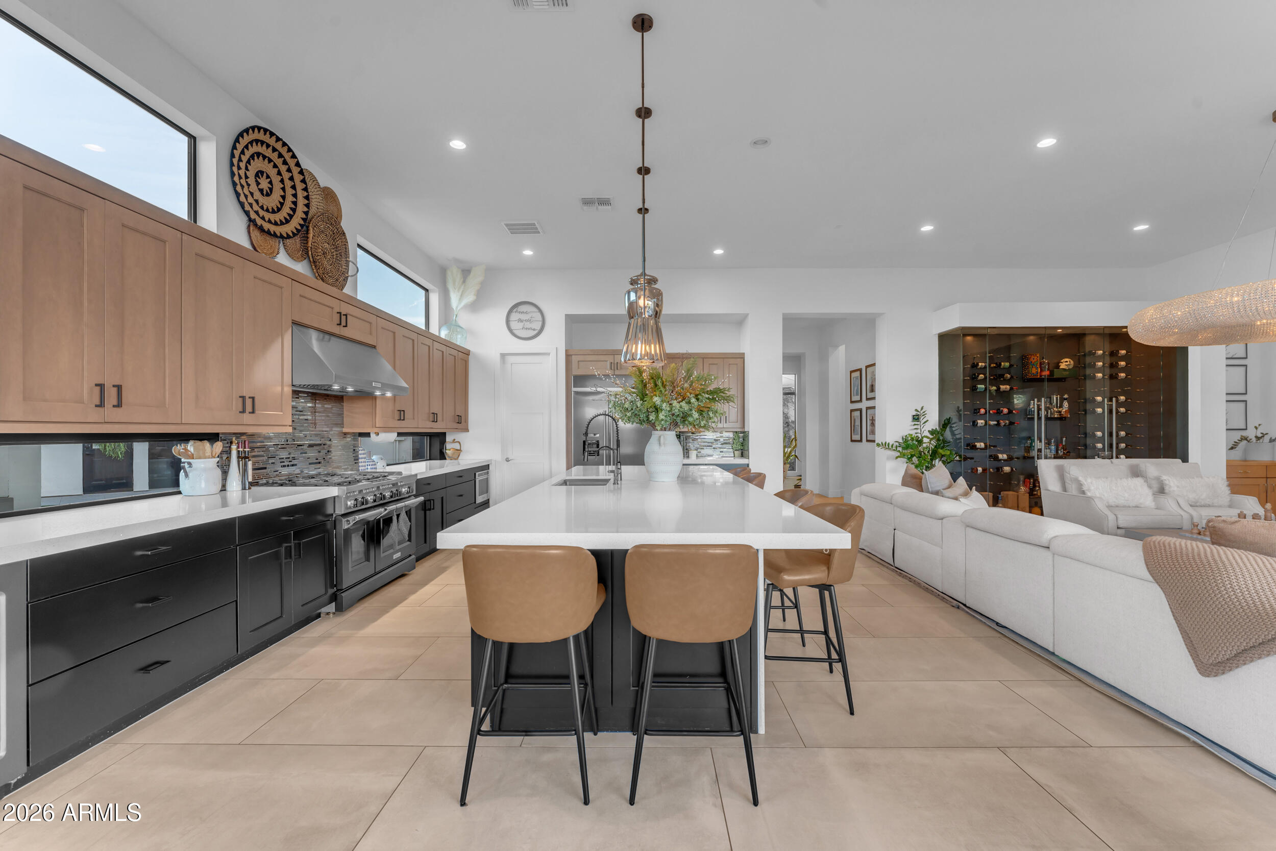 3908 East Alameda Lane Gilbert, AZ 85298 - Photo 23 of 62 a living room with stainless steel appliances kitchen island granite countertop a stove a sink a dining table and chairs with wooden floor