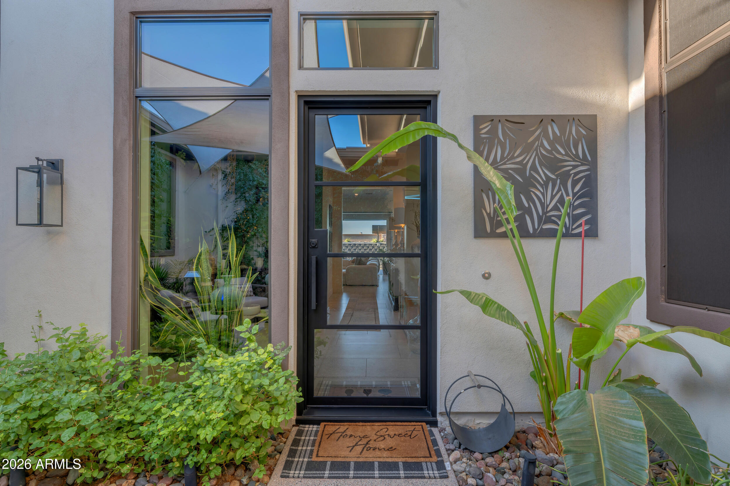 3908 East Alameda Lane Gilbert, AZ 85298 - Photo 5 of 62 a vase of flowers sitting on a table in front of a door
