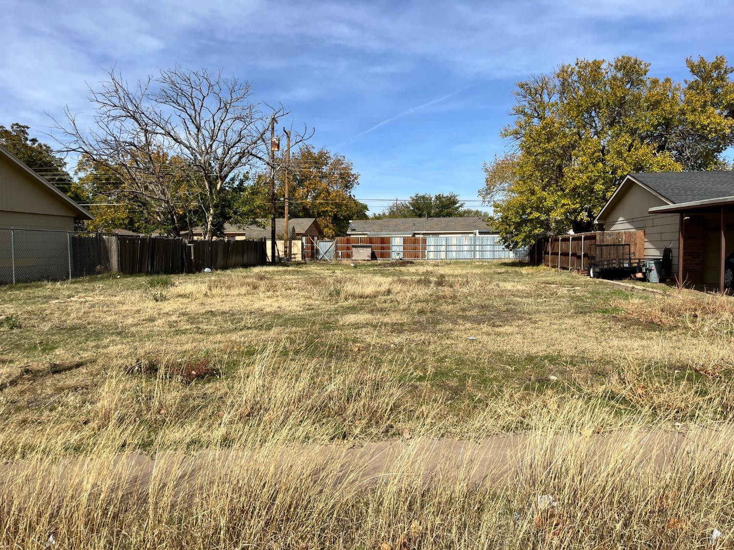 5430 48th Street Lubbock, TX 79414 - Photo 1 of 1 a tall yellow house with trees in front of it