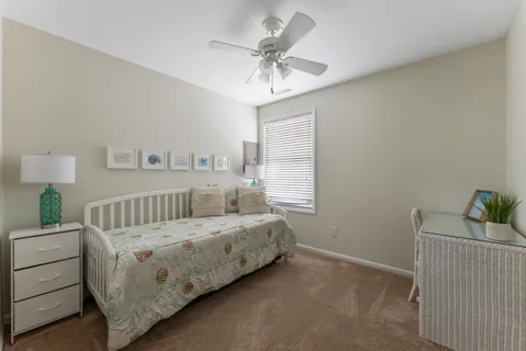a bedroom with a bed and a ceiling fan
