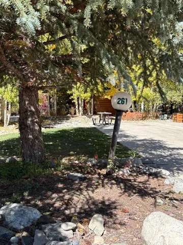 a backyard of a house with table and chairs