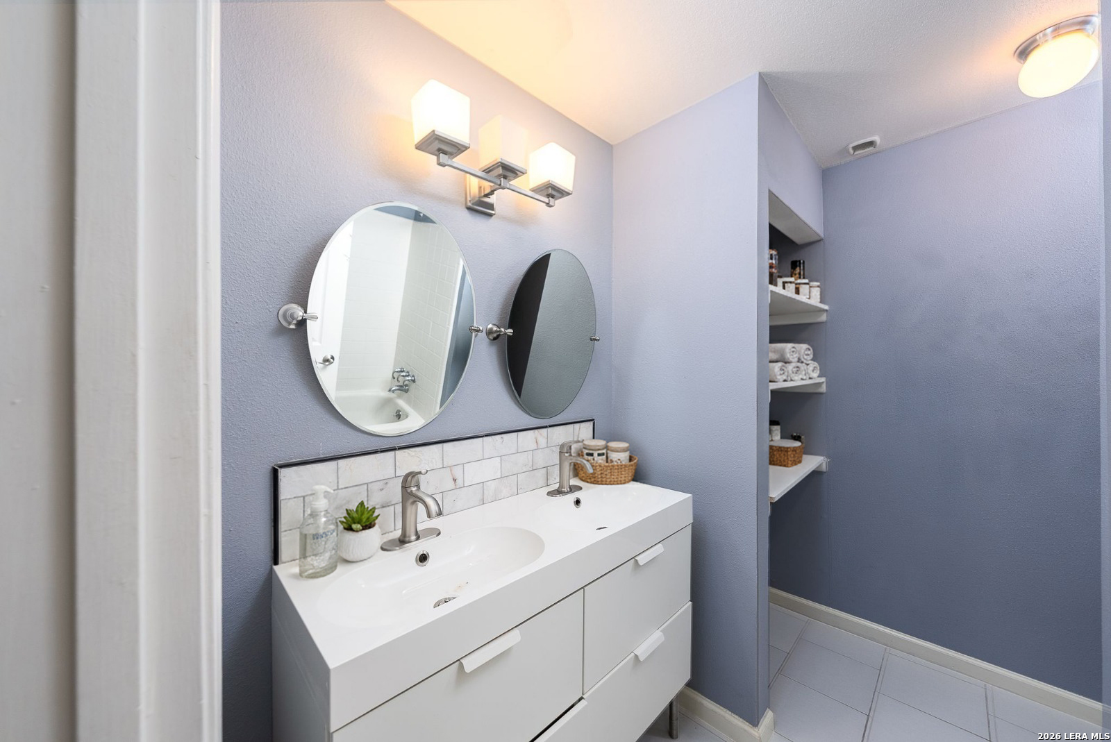 7711 Callaghan Road, Unit 805 San Antonio, TX 78229 - Photo 17 of 33 a bathroom with a sink and a mirror