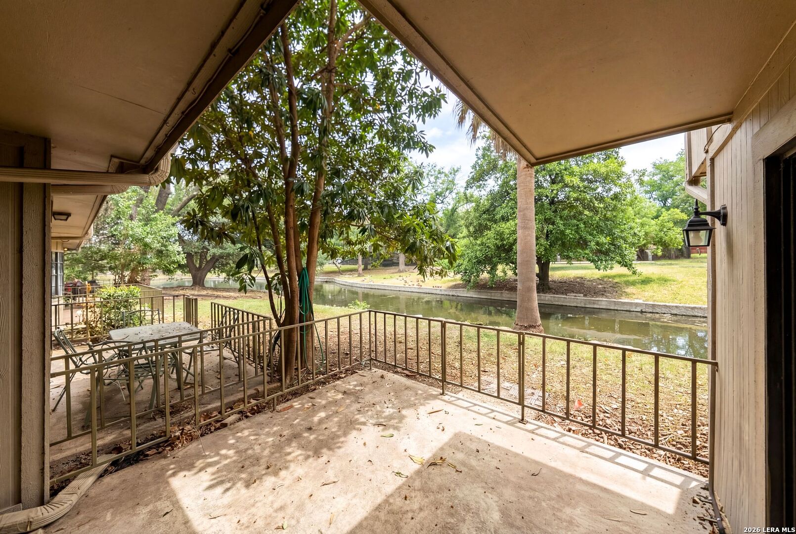 7711 Callaghan Road, Unit 805 San Antonio, TX 78229 - Photo 26 of 33 a view of backyard with large trees and wooden fence