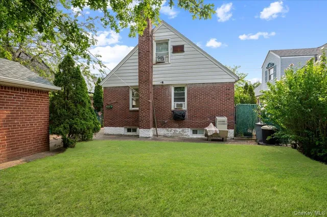 a view of a house with a yard and sitting area