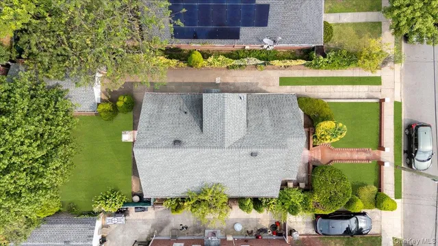 an aerial view of a house with a yard and a garden
