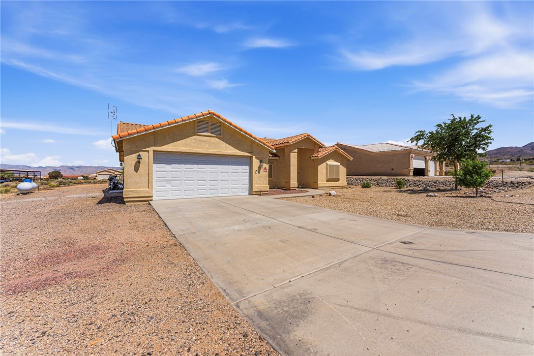 9332 Branded Road Kingman, AZ 86401 - Photo 31 of 44 a front view of a house with a yard