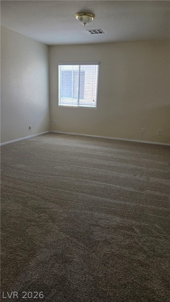 9031 Spring Star Court Las Vegas, NV 89148 - Photo 11 of 17 Well-lit room features soft carpet and a window with horizontal blinds.