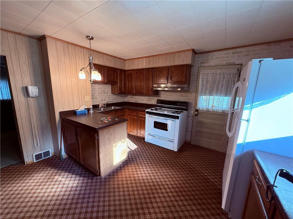 9 Kennedy Street Republic, PA 15475 - Photo 7 of 24 a kitchen with stainless steel appliances a stove a sink and a refrigerator