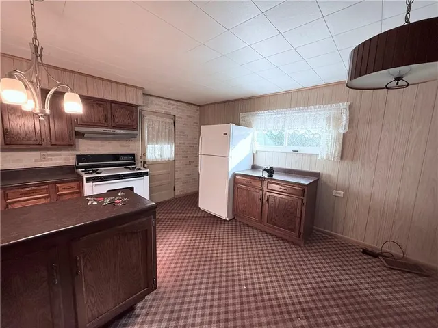 a kitchen with a refrigerator and a stove