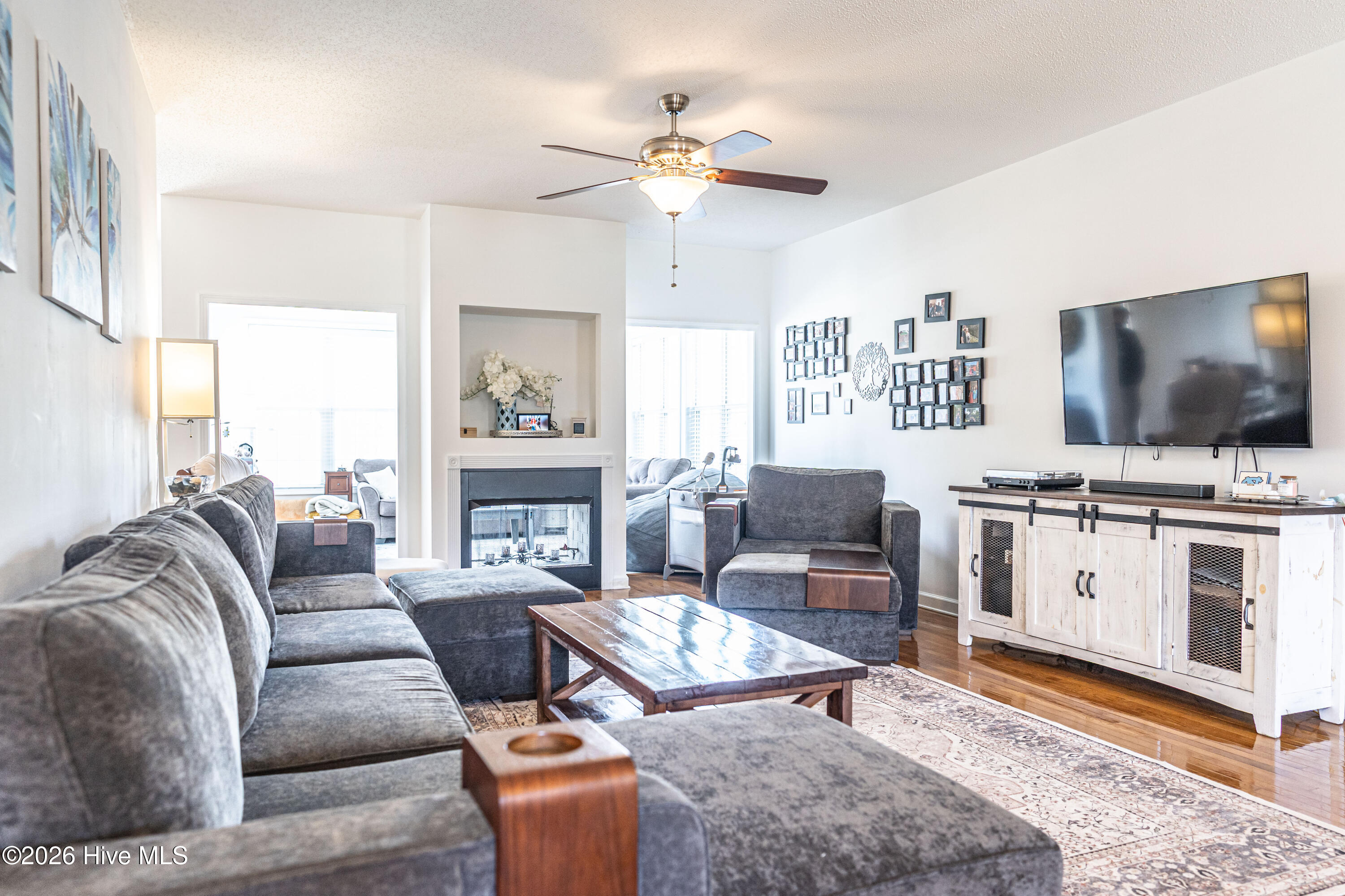 1320 Burning Tree Road Pinehurst, NC 28374 - Photo 8 of 60 Living Room opening to Carolina Room with 2-sided fireplace