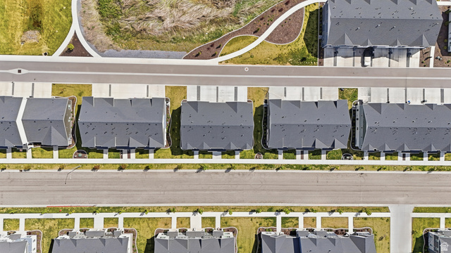 1173 West 1870 South Logan, UT 84321 - Photo 28 of 33 Aerial perspective showcasing a community of properties with dark grey roofs