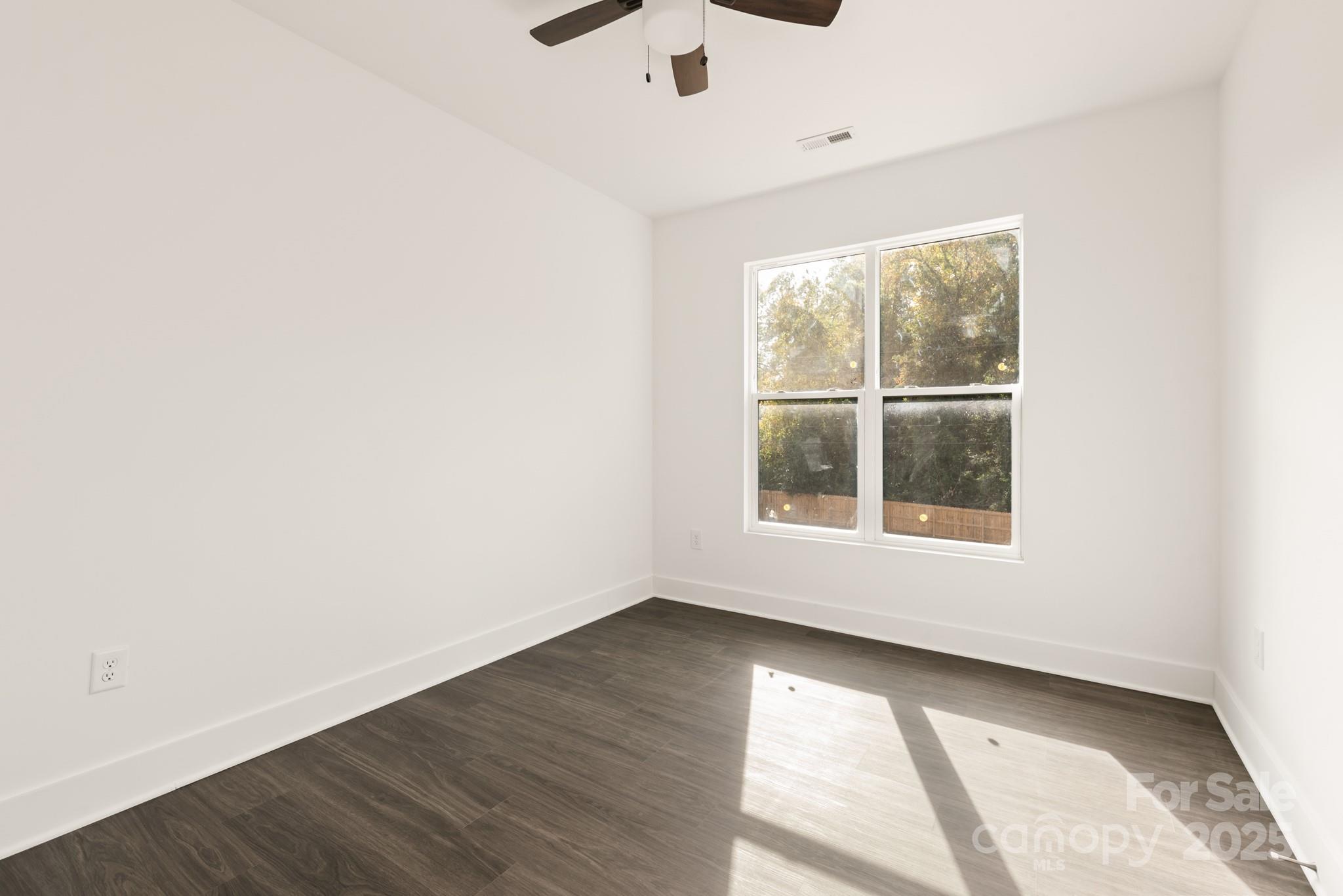 9000 Boyd Drive Matthews, NC 28105 - Photo 21 of 30 an empty room with wooden floor and windows