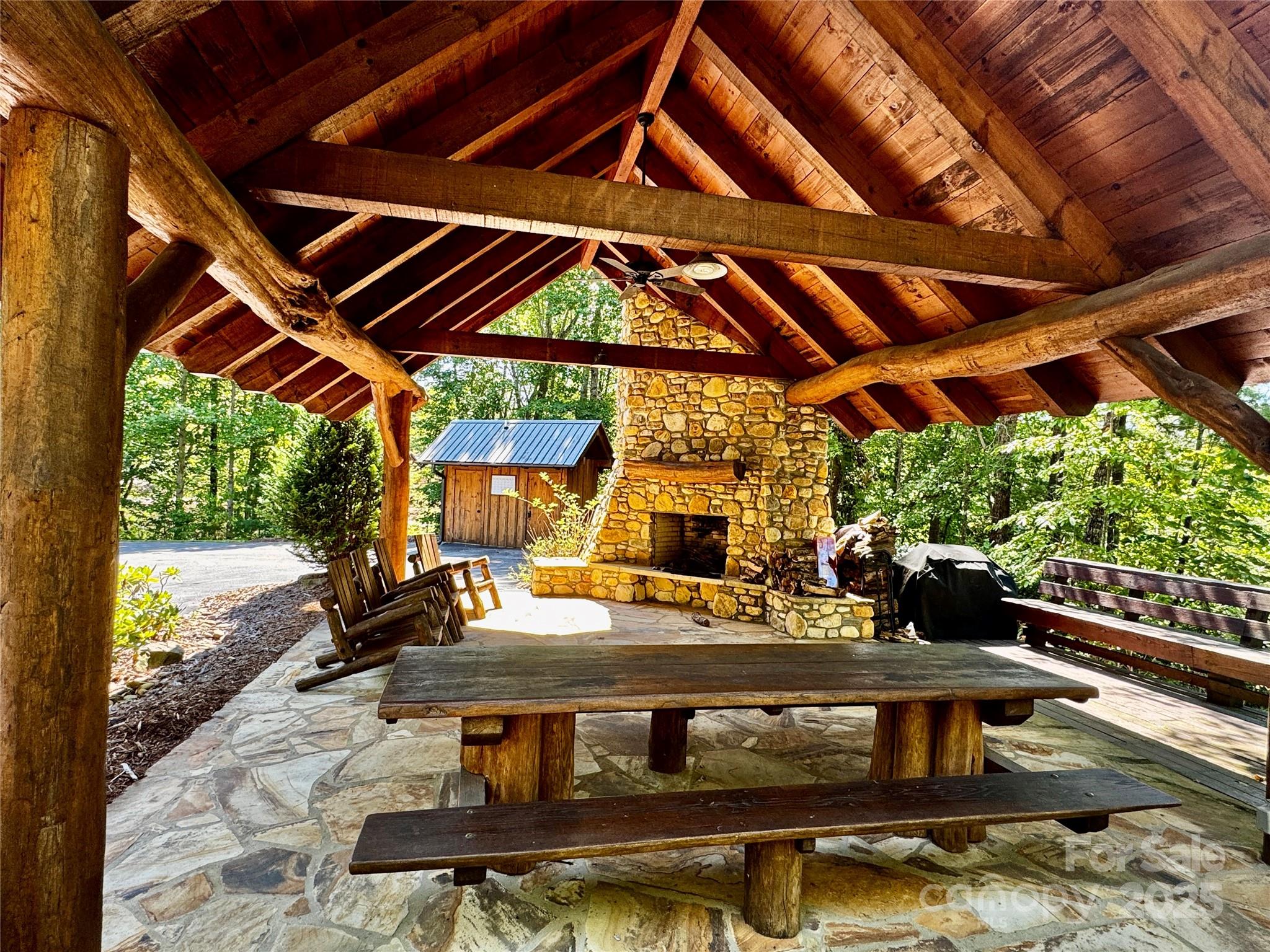 178 Beacon Ridge Drive Nebo, NC 28761 - Photo 19 of 20 a view of a backyard with table and chairs under an umbrella with a small yard