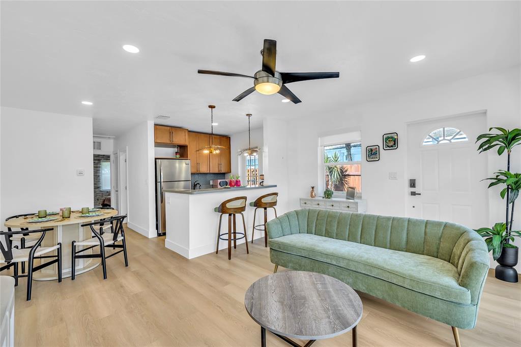 2412 Northeast 4th Street, Unit W Pompano Beach, FL 33062 - Photo 11 of 25 a living room with furniture and a flat screen tv