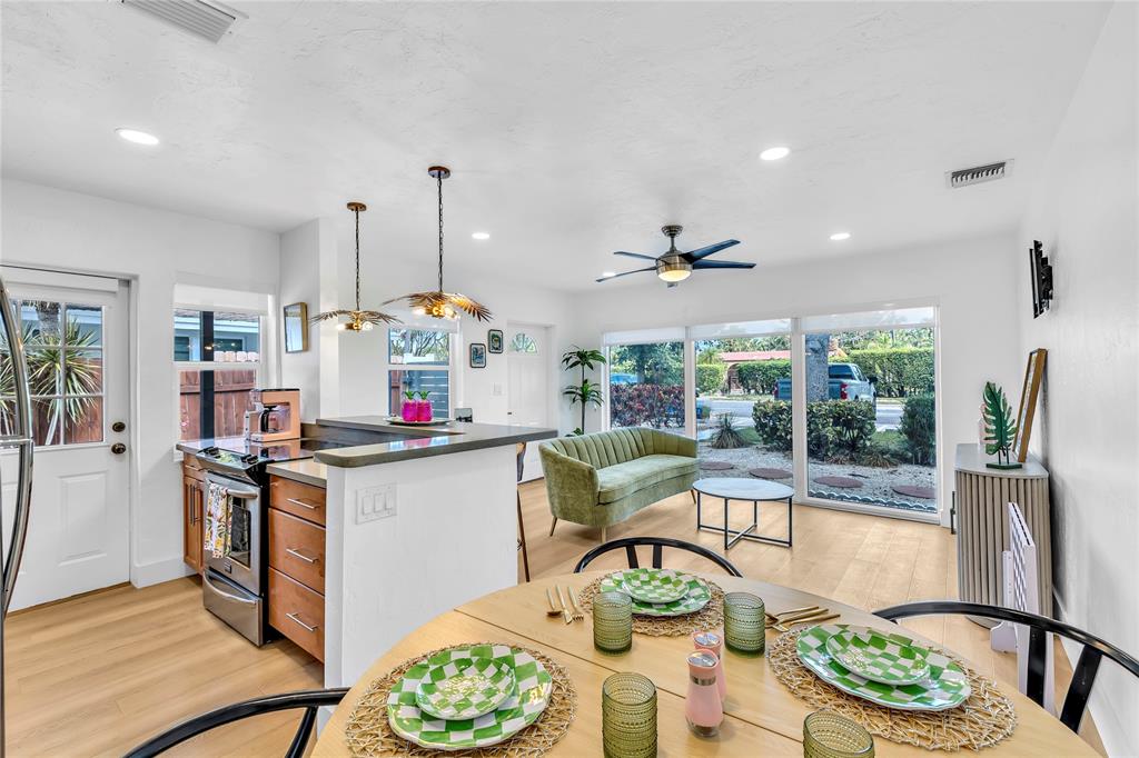 2412 Northeast 4th Street, Unit W Pompano Beach, FL 33062 - Photo 12 of 25 a kitchen with stainless steel appliances granite countertop a stove and refrigerator