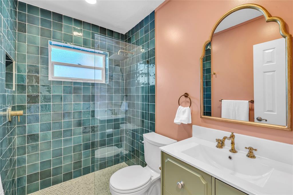 2412 Northeast 4th Street, Unit W Pompano Beach, FL 33062 - Photo 18 of 25 a bathroom with a sink mirror and toilet