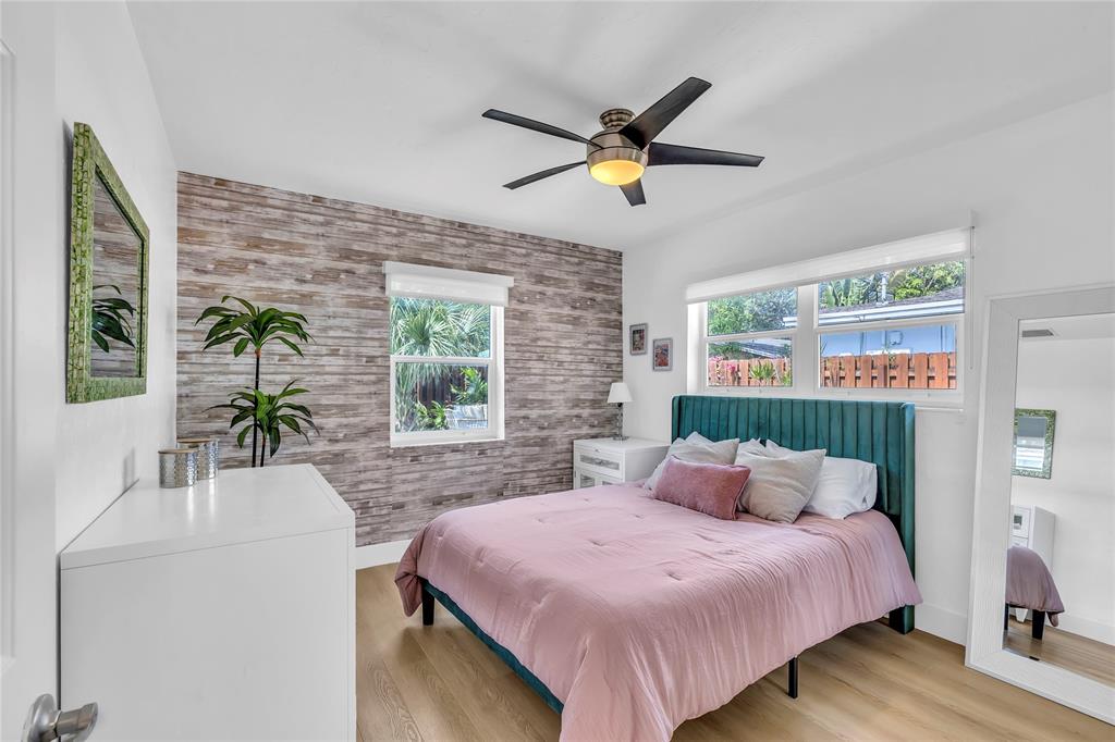 2412 Northeast 4th Street, Unit W Pompano Beach, FL 33062 - Photo 19 of 25 a bedroom with a bed a dresser next to a window