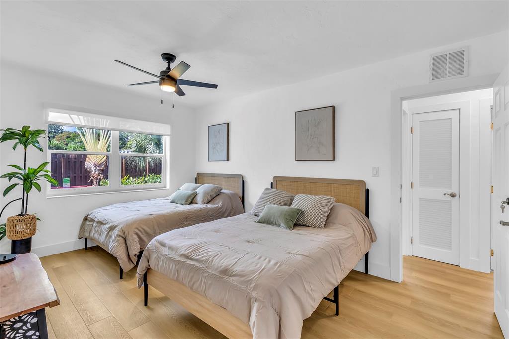 2412 Northeast 4th Street, Unit W Pompano Beach, FL 33062 - Photo 20 of 25 a bedroom with double bed and a window