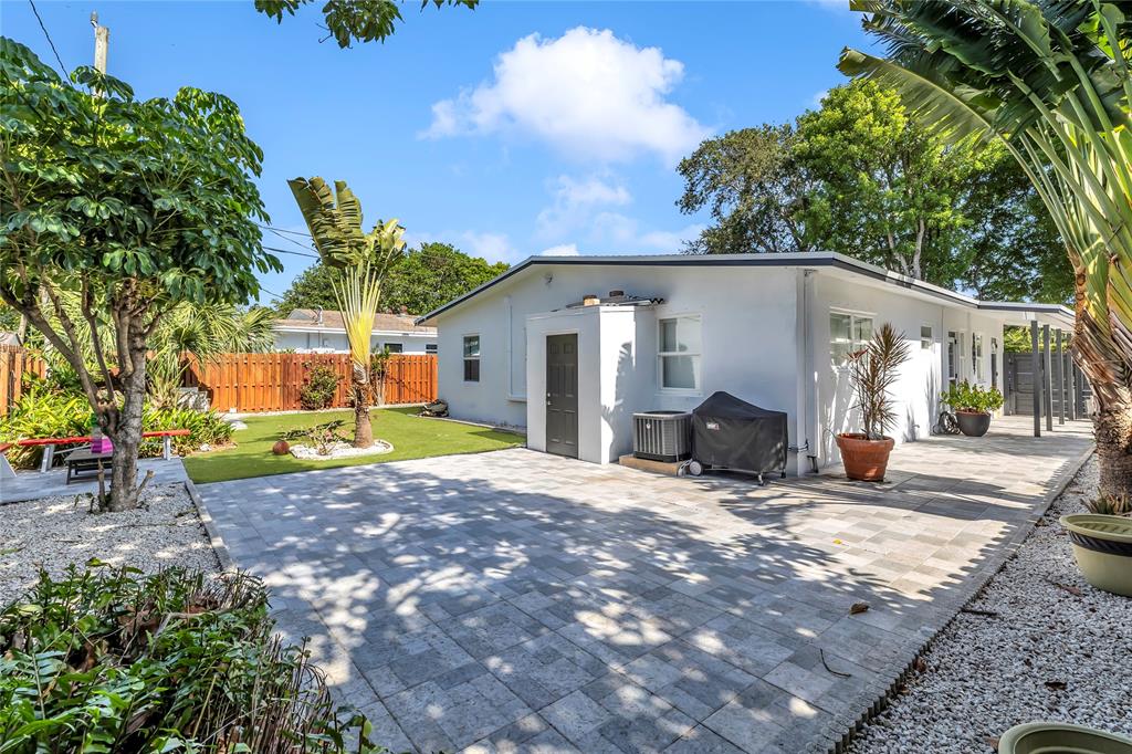 2412 Northeast 4th Street, Unit W Pompano Beach, FL 33062 - Photo 22 of 25 a view of a house with backyard and sitting area