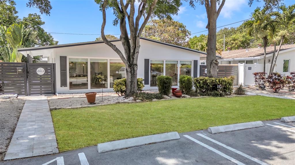 2412 Northeast 4th Street, Unit W Pompano Beach, FL 33062 - Photo 4 of 25 a view of a house with backyard sitting area and garden