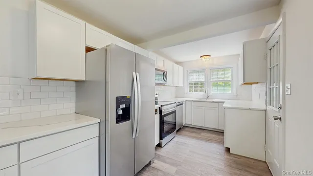 a kitchen with a refrigerator stove and sink