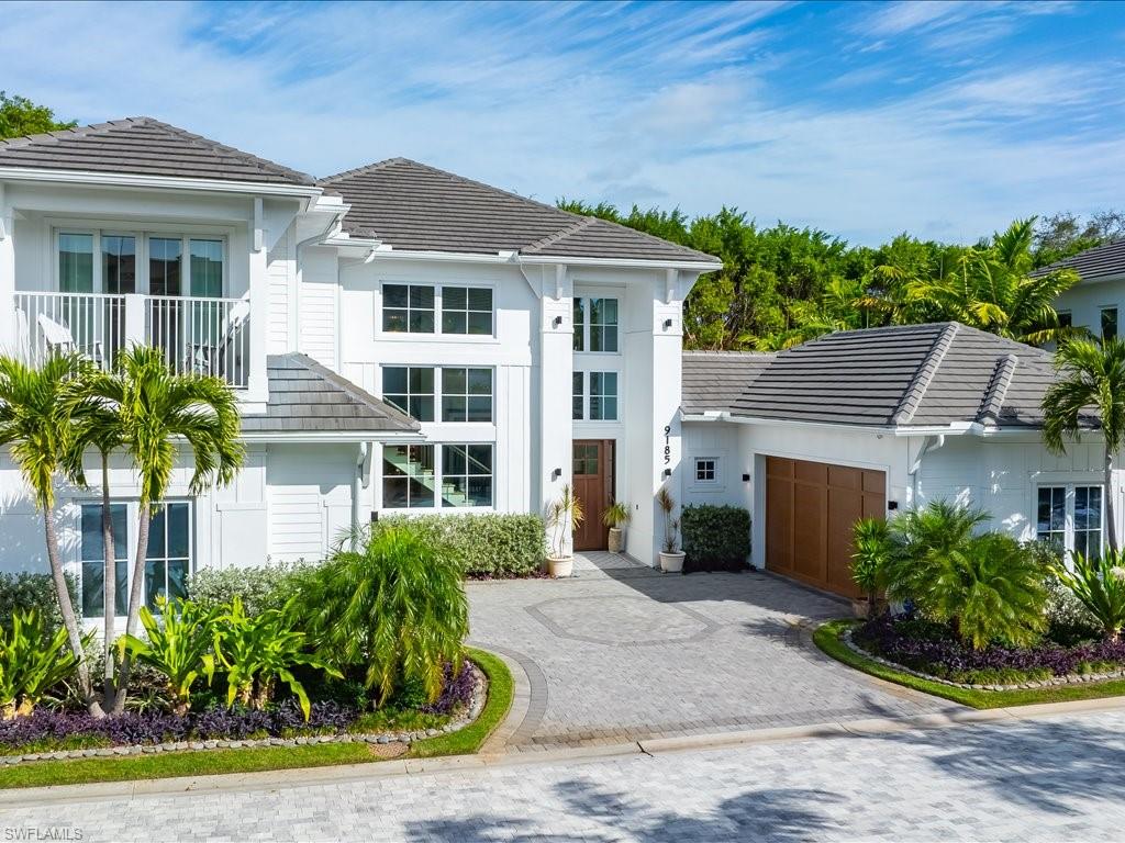 9185 Mercato Way Naples, FL 34108 - Photo 13 of 50 a front view of a house with a yard
