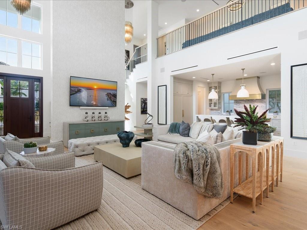 9185 Mercato Way Naples, FL 34108 - Photo 16 of 50 a living room with furniture and a flat screen tv