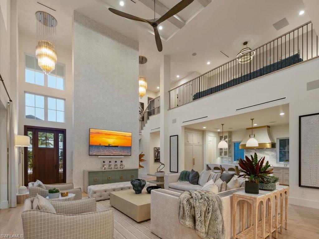 9185 Mercato Way Naples, FL 34108 - Photo 17 of 50 a living room with furniture and a flat screen tv