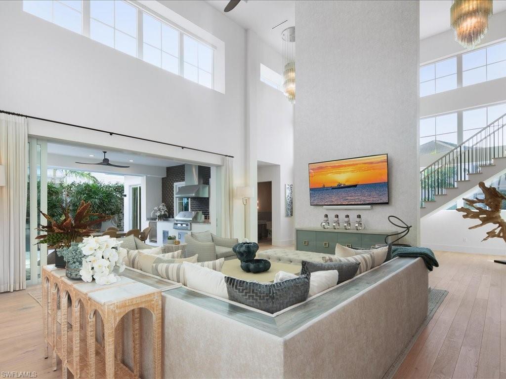 9185 Mercato Way Naples, FL 34108 - Photo 18 of 50 a living room with fireplace furniture and a flat screen tv