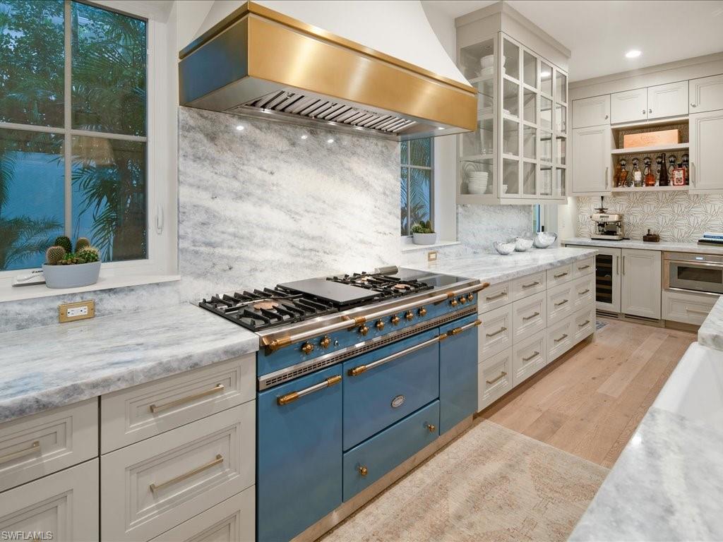 9185 Mercato Way Naples, FL 34108 - Photo 22 of 50 a kitchen with stainless steel appliances granite countertop a stove and a sink