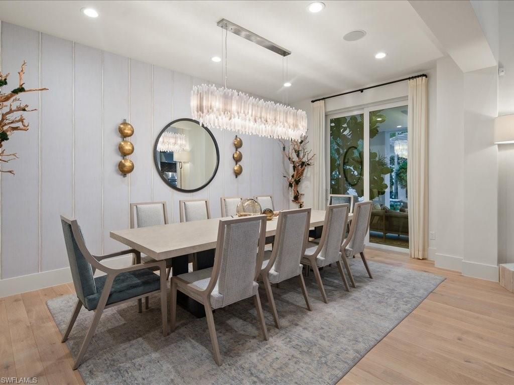 9185 Mercato Way Naples, FL 34108 - Photo 25 of 50 a dining room with furniture a window and a rug