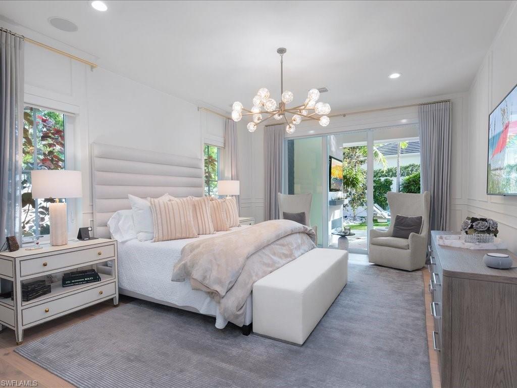 9185 Mercato Way Naples, FL 34108 - Photo 27 of 50 a bedroom with a bed chandelier and window