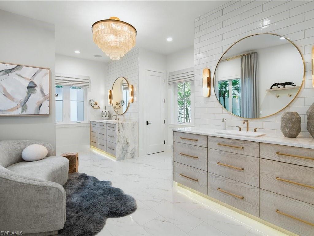 9185 Mercato Way Naples, FL 34108 - Photo 28 of 50 a spacious bathroom with double vanity sink and a mirror