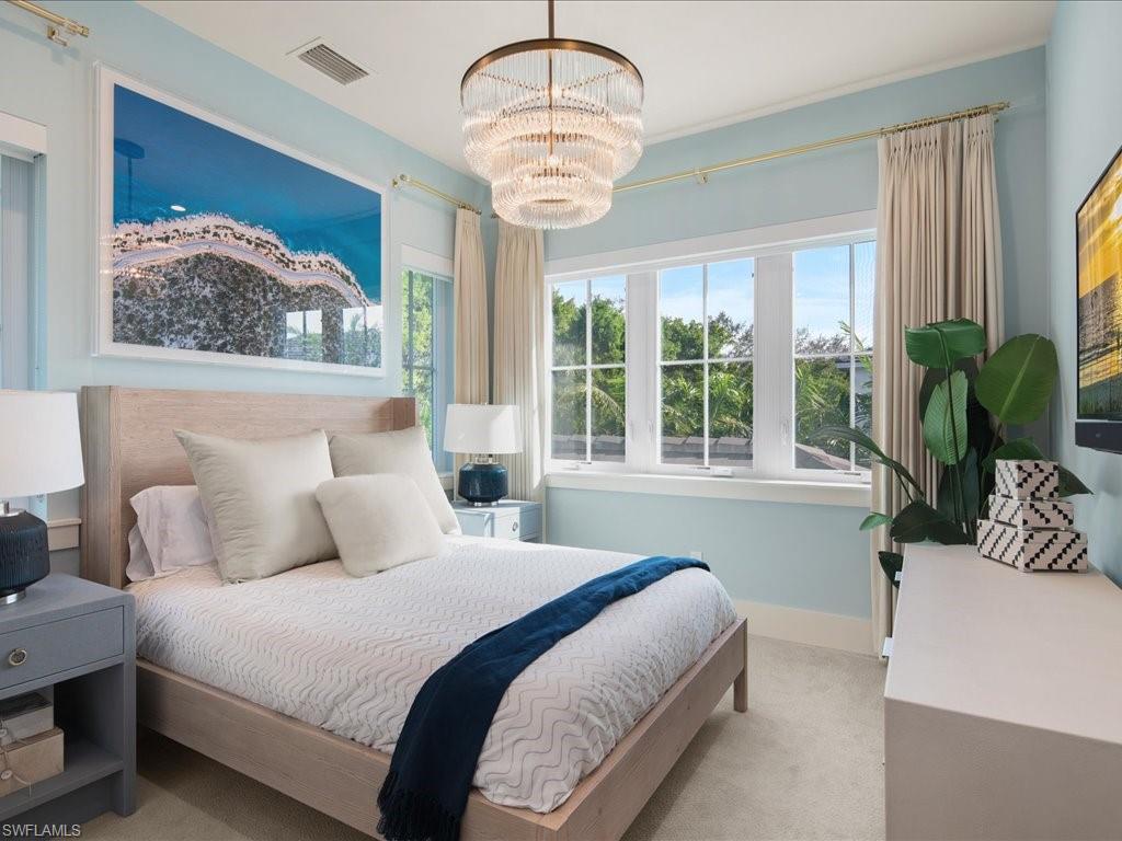 9185 Mercato Way Naples, FL 34108 - Photo 34 of 50 a bedroom with a large bed and a large window