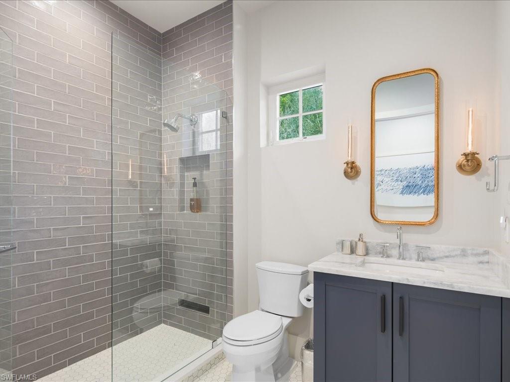 9185 Mercato Way Naples, FL 34108 - Photo 35 of 50 a bathroom with a sink a toilet and shower