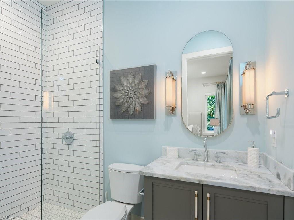 9185 Mercato Way Naples, FL 34108 - Photo 38 of 50 a bathroom with a granite countertop toilet sink and mirror